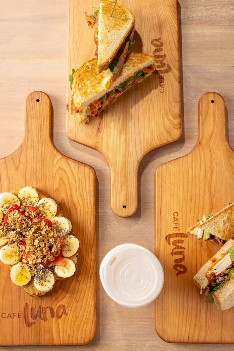 Sandwiches and a smoothie bowl on Café Luna wooden boards