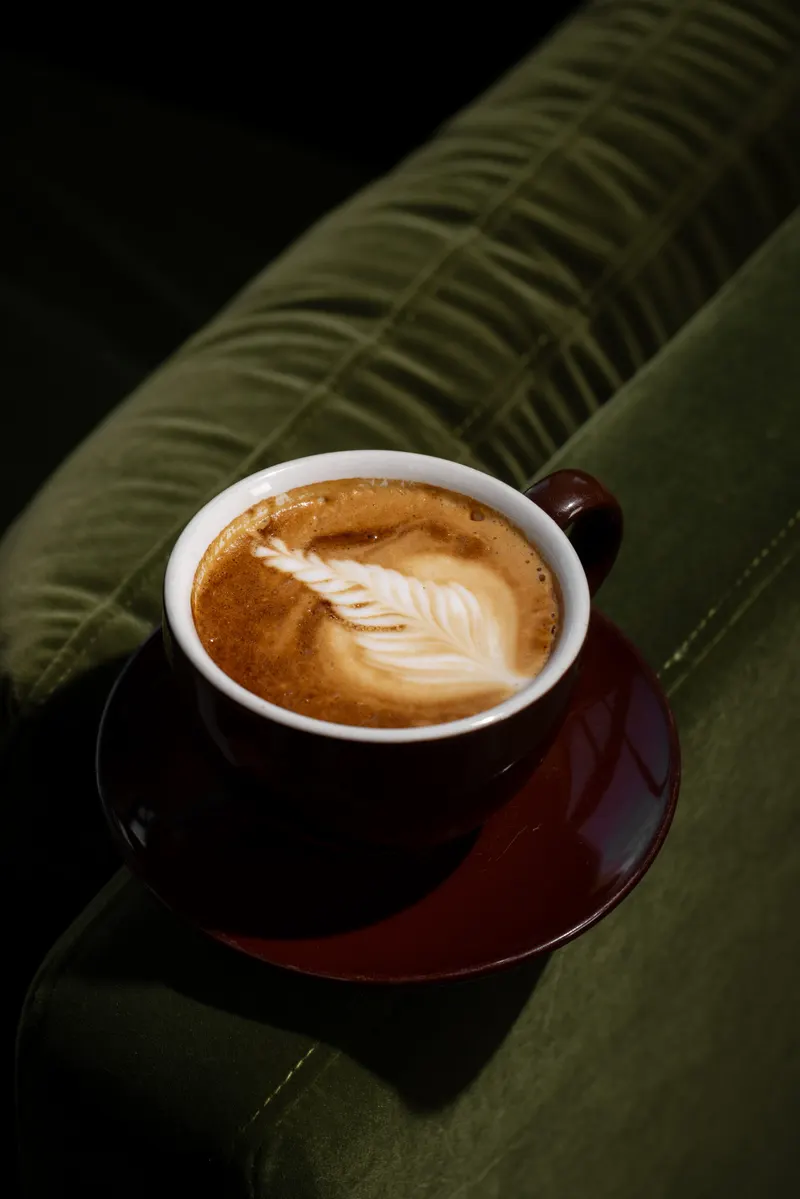 Latte with art in a dark mug