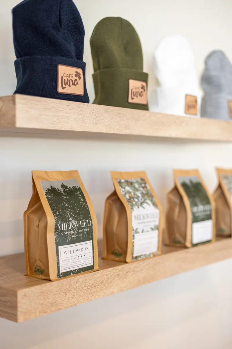 Café Luna beanies and bagged coffee on shelves